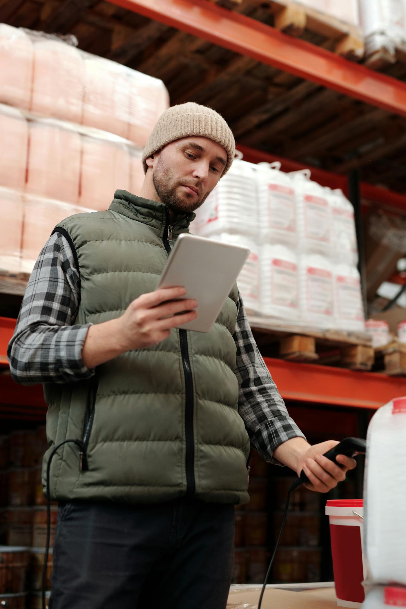 Warehouse team member using a tablet to review stock and purchase records