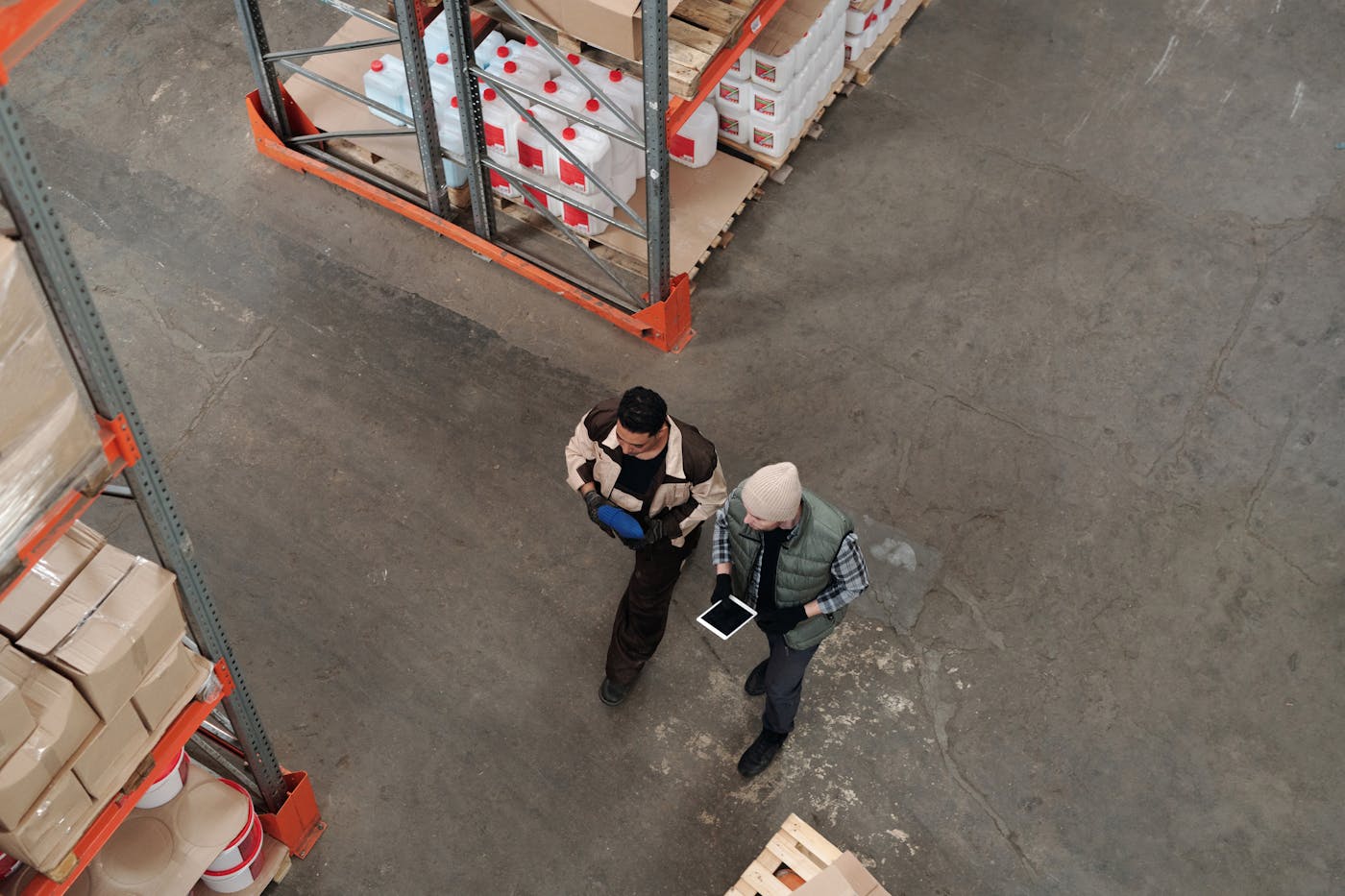 Warehouse staff reviewing inventory information on a tablet